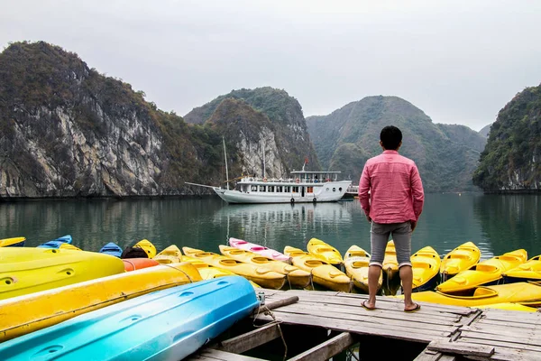 Traveler Man relaxing meditation in halong bay and enjoy the bea