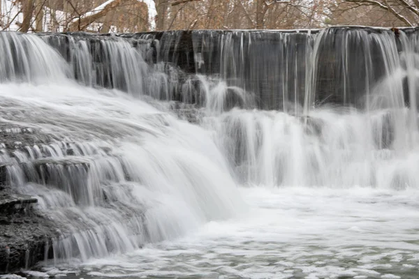 stock image Small river cascade step winter time