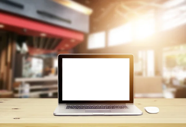 Laptop computer with blank screen on wood table in architect office — Stock Photo, Image