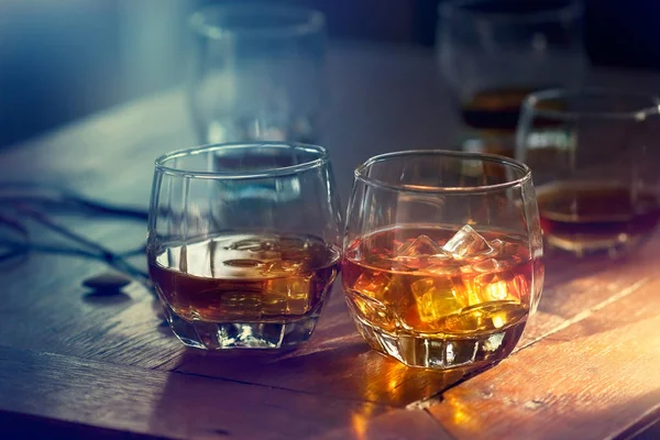 Whisky bourbon en un vaso con hielo sobre mesa de madera — Foto de Stock