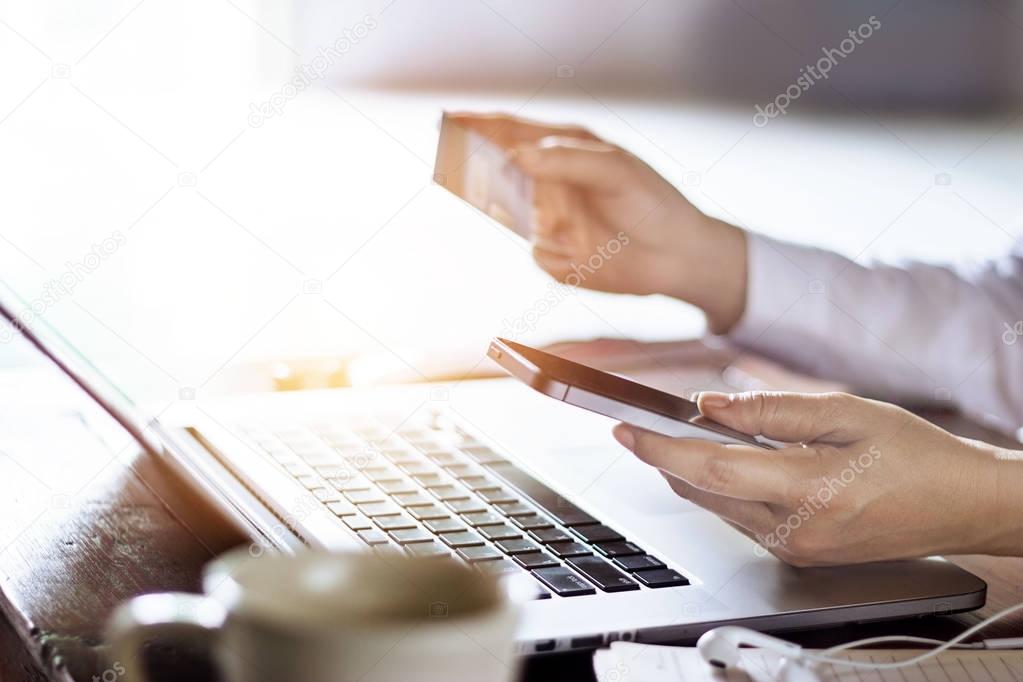 Man using mobile payments with credit card for online shopping 