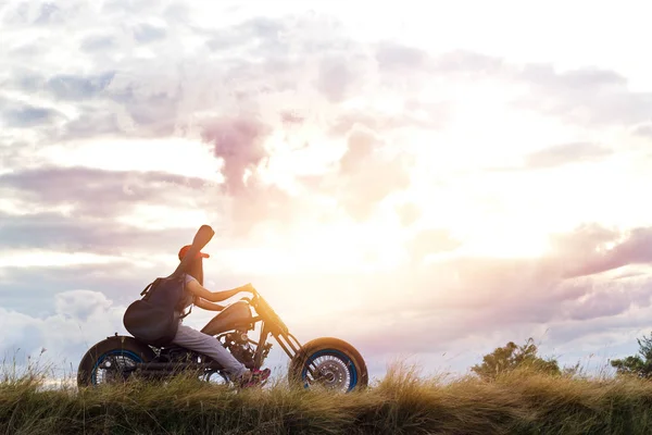 Chitarrista donna a cavallo di una moto sulla strada di campagna — Foto Stock