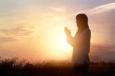 Dua, doğa günbatımı arka plan üzerinde meditasyon kadın