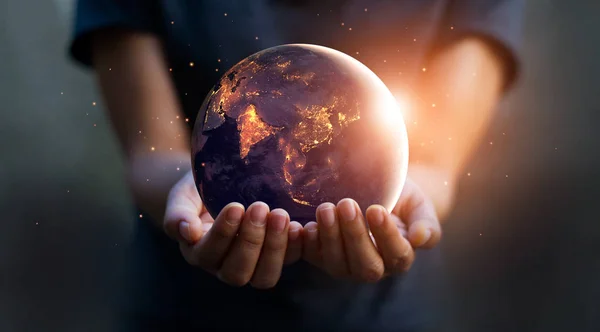 Earth at night was holding in human hands. Earth day. Energy sav — Stock Photo, Image