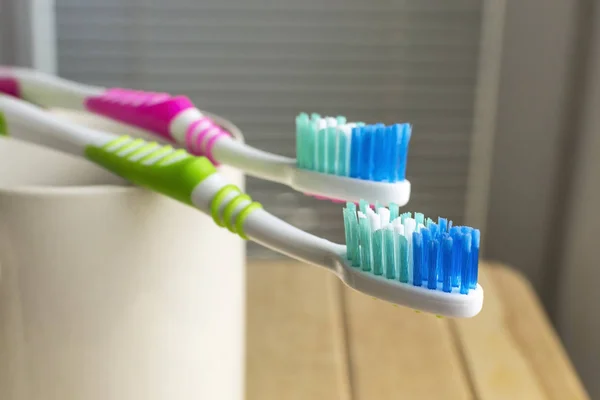 Toothbrushes on the white cup — Stock Photo, Image