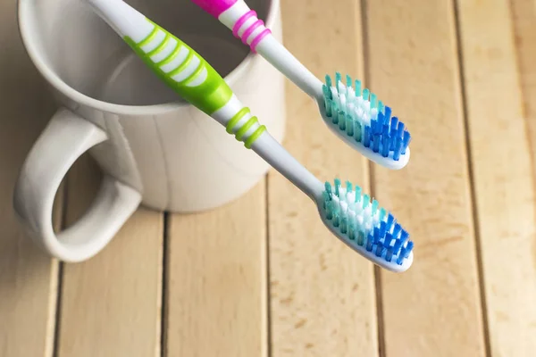 Toothbrushes on the white cup — Stock Photo, Image