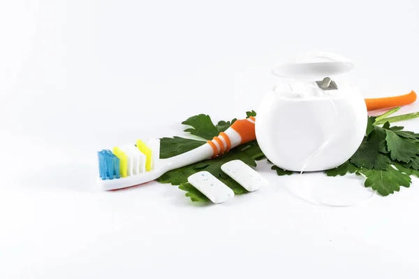 Toothbrush and dental floss on white background — Stock Photo, Image