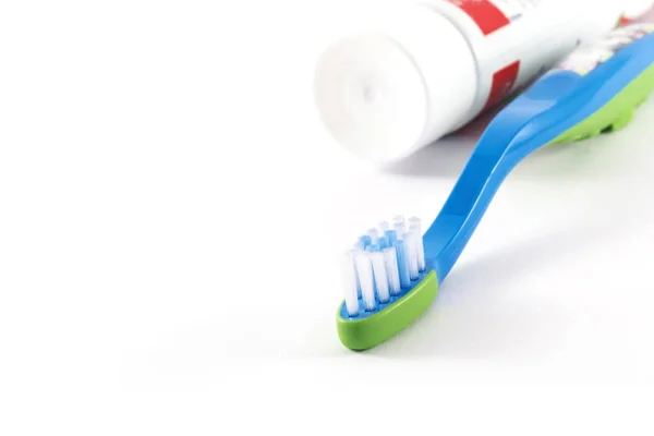 Baby toothbrush and toothpaste on white background — Stock Photo, Image