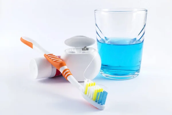 Toothbrush, toothpaste, dental floss and mouthwash on white background — Stock Photo, Image