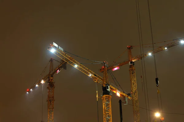 Grúas amarillas hree en la luz amarilla de la noche —  Fotos de Stock