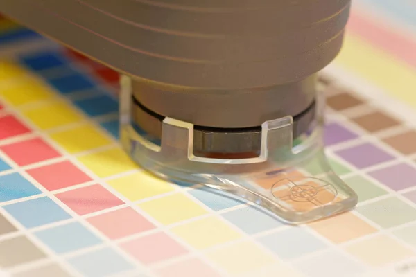 Spectrometer used for proofing on a leaf of the test print — Stock Photo, Image