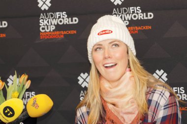 STOCKHOLM, SWEDEN - JAN 30, 2017: Laughing Mikaela Shiffrin interviewed at a press conference before the parallel slalom, Audi FIS Ski World Cup. January 30, 2017, Stockholm, Sweden clipart