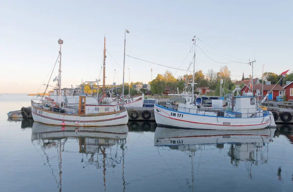 Many fishing boats in the rural harbor at sunrise — Stock Photo, Image