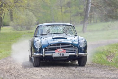 Stockholm, İsveç - 22 Mayıs 2017: 1965 sürüş ormanlarında Gardesloppet genel yarış bir ülkede yol Djurgarden, Stokholm, İsveç gelen siyah bir Aston Martin salon klasik araba. 22 Mayıs 2017