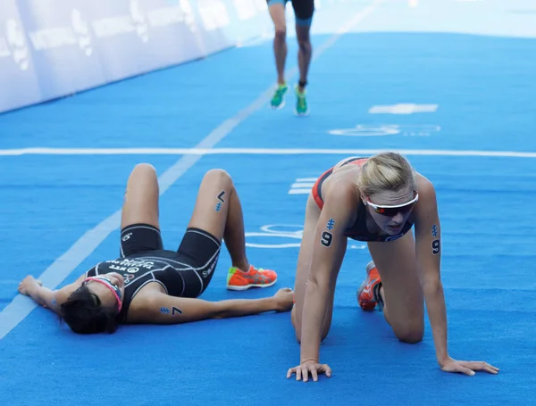 Exhausted triathletes after the finish — Stock Photo, Image