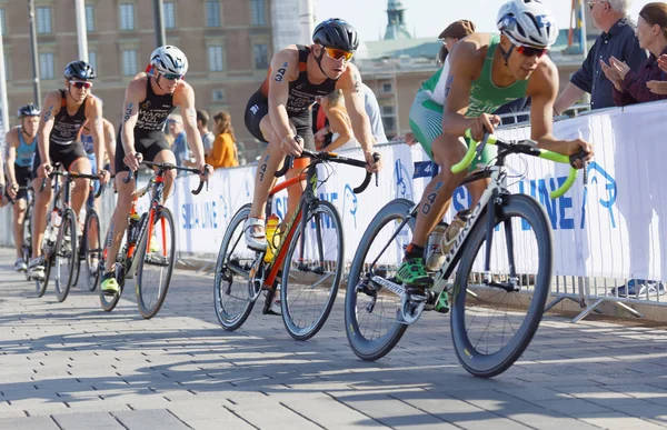 Back of group of colorful triathlete cyclists — Stock Photo, Image