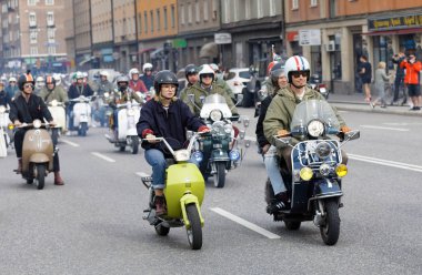 STOCKHOLM, SWEDEN - SEPT 02, 2017: Mods driving old fashioned vespa scooter with many lamps at the Mods vs Rockers event at the Saint Eriks bridge, Stockholm, Sweden, September 02, 2017