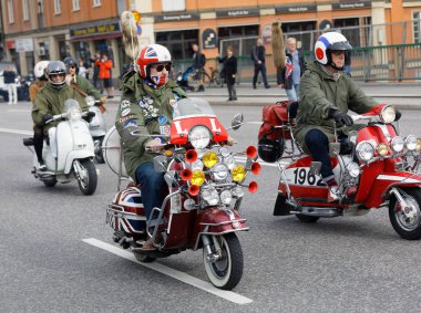 STOCKHOLM, SWEDEN - SEPT 02, 2017: Mods driving old fashioned vespa scooter with many lamps at the Mods vs Rockers event at the Saint Eriks bridge, Stockholm, Sweden, September 02, 2017