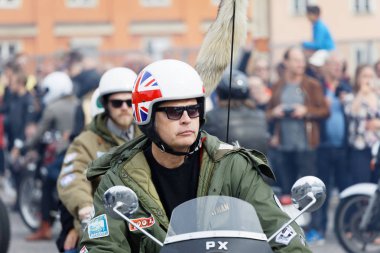 STOCKHOLM, SWEDEN - SEPT 02, 2017: Closeup of mods wearing old fashioned clothes driving old fashioned vespa scooter at the Mods vs Rockers event at the Saint Eriks bridge, Stockholm, Sweden, September 02, 2017