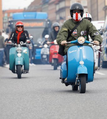 STOCKHOLM, SWEDEN - SEPT 02, 2017: Closeup of mods wearing old fashioned clothes driving beautiful old fashioned vespa scooter at the Mods vs Rockers event at the Saint Eriks bridge, Stockholm, Sweden, September 02, 2017