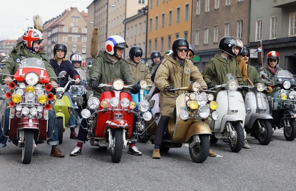 STOCKHOLM, SWEDEN - SEPT 02, 2017: Closeup of large group of mods on old fashioned vespas at the Mods vs Rockers event at the Saint Eriks bridge, Stockholm, Sweden, September 02, 2017