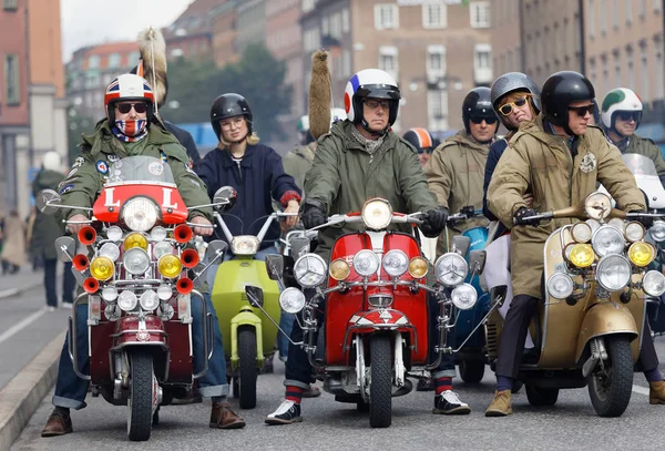 STOCKHOLM, SWEDEN - SEPT 02, 2017: Closeup of group of mods on old fashioned vespas at the Mods vs Rockers event at the Saint Eriks bridge, Stockholm, Sweden, September 02, 2017