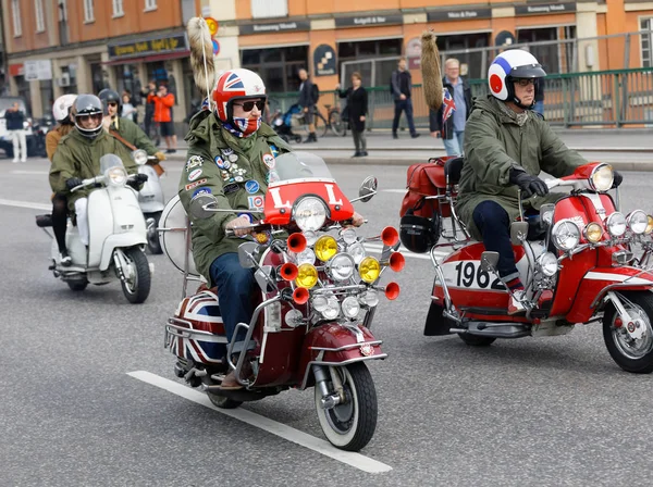 STOCKHOLM, SWEDEN - SEPT 02, 2017: Mods driving old fashioned vespa scooter with many lamps at the Mods vs Rockers event at the Saint Eriks bridge, Stockholm, Sweden, September 02, 2017