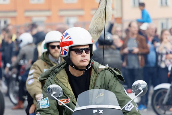 STOCKHOLM, SWEDEN - SEPT 02, 2017: Closeup of mods wearing old fashioned clothes driving old fashioned vespa scooter at the Mods vs Rockers event at the Saint Eriks bridge, Stockholm, Sweden, September 02, 2017