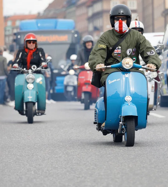 STOCKHOLM, SWEDEN - SEPT 02, 2017: Closeup of mods wearing old fashioned clothes driving beautiful old fashioned vespa scooter at the Mods vs Rockers event at the Saint Eriks bridge, Stockholm, Sweden, September 02, 2017