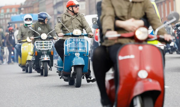 STOCKHOLM, SWEDEN - SEPT 02, 2017: Closeup of mods wearing old fashioned clothes driving beautiful old fashioned vespa scooter at the Mods vs Rockers event at the Saint Eriks bridge, Stockholm, Sweden, September 02, 2017