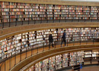 STOCKHOLM, OCT 30 2017: People in the city library in Stockholm called Stadsbiblioteket, in beautiful central rotunda. October 30, 2017, Stockholm, Sweden. clipart