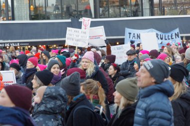 STOCKHOLM, SWEDEN - JAN 21, 2018: Young women holding a placard in the Womens March, a worldwide protest for women's rights in central Stockholm, Norrmalmstorg, Sweden, January 21, 2018 clipart