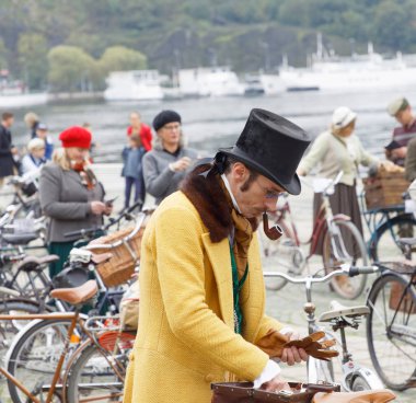 Stockholm - 23 Eylül 2017: Zarif üst sınıf beyefendi sarı Mont ve pantolon ve bir silindir şapka aprox 1900 Tweed olay bisiklet içinde Stockholm, İsveç'te 23 Eylül 2017 giyinmiş bisiklet ile