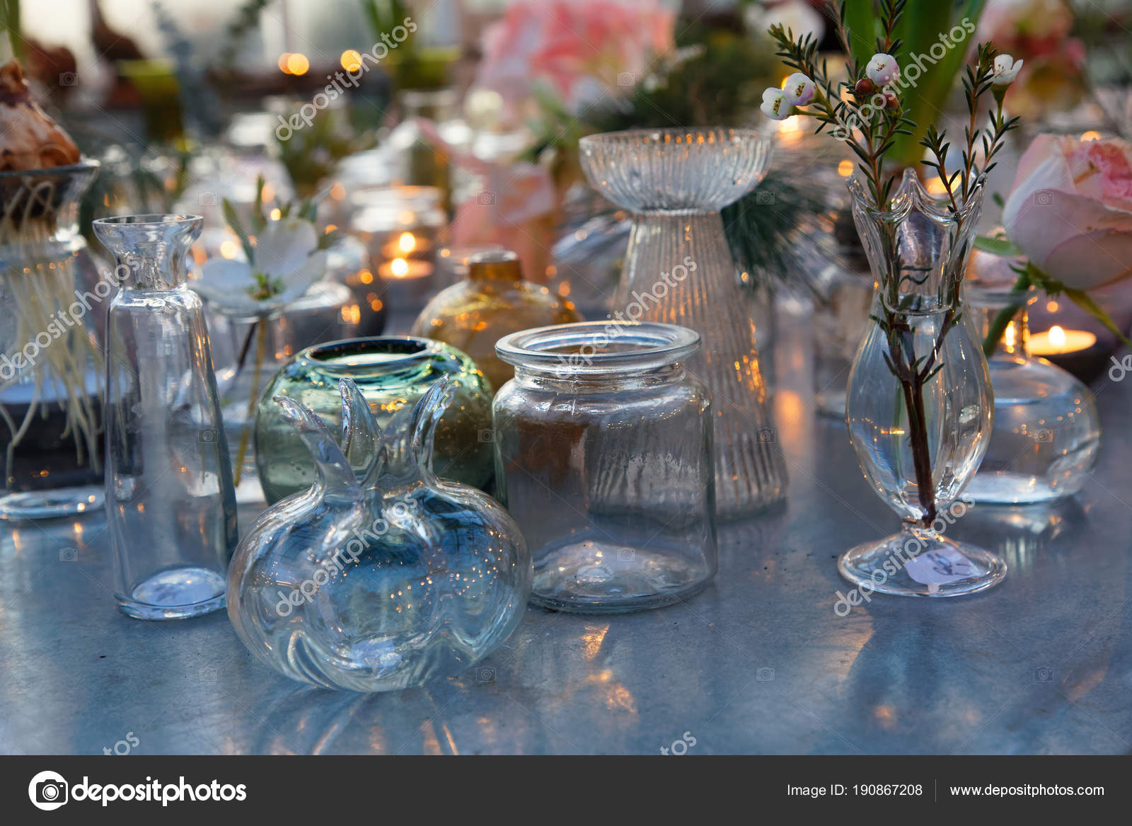 Many Glass Vase In Different Shapes With Flowers On A Table