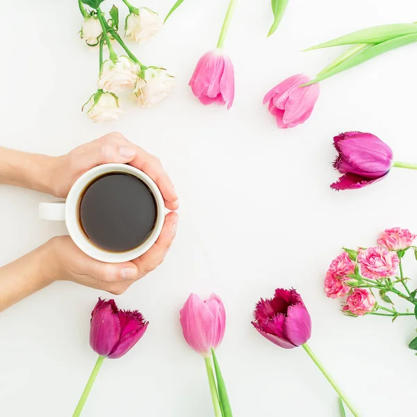 Flores y taza de café en las manos — Foto de Stock