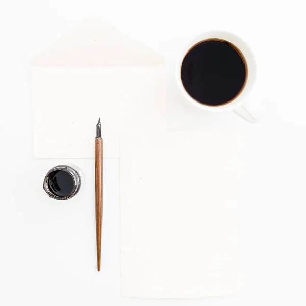 Vintage sheet of paper with dip pen and inkstand on white background with cup of coffee