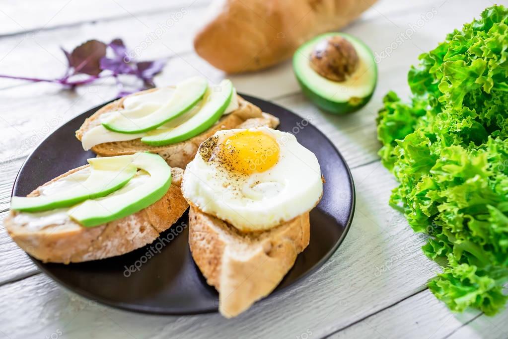 Tasty sandwiches with avocado and egg