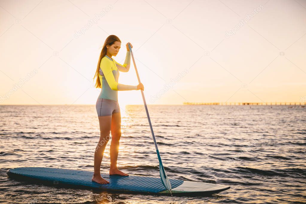 Girl stand up paddle boarding 