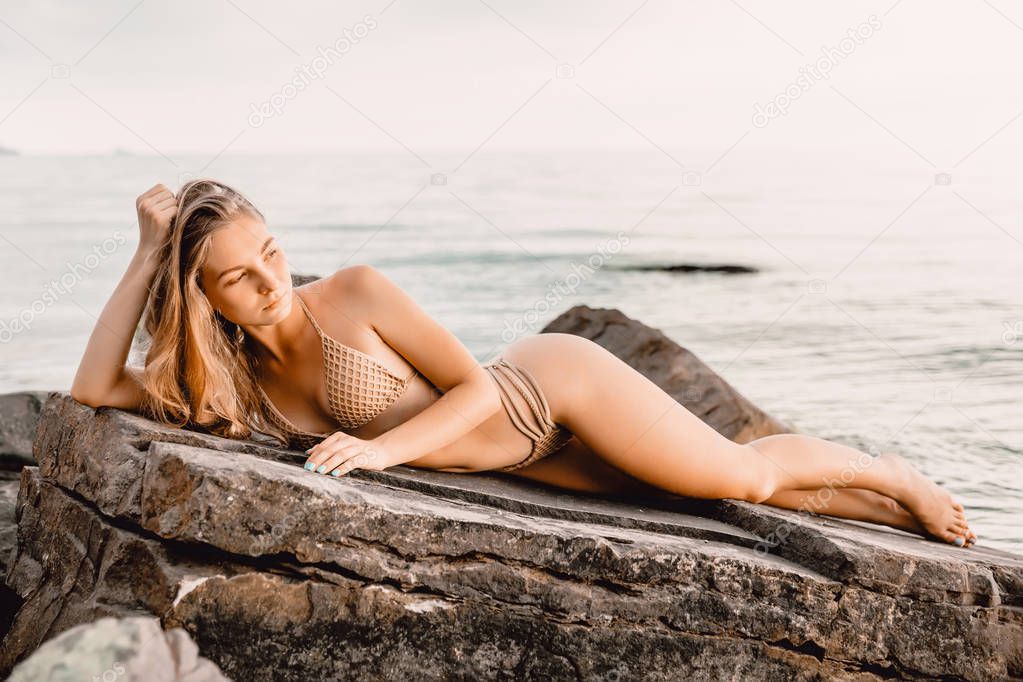 woman relaxing on rock 