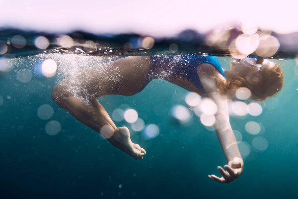 Woman  floating in quiet ocean.