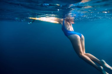 Sessiz bir okyanusta yüzen kadın.