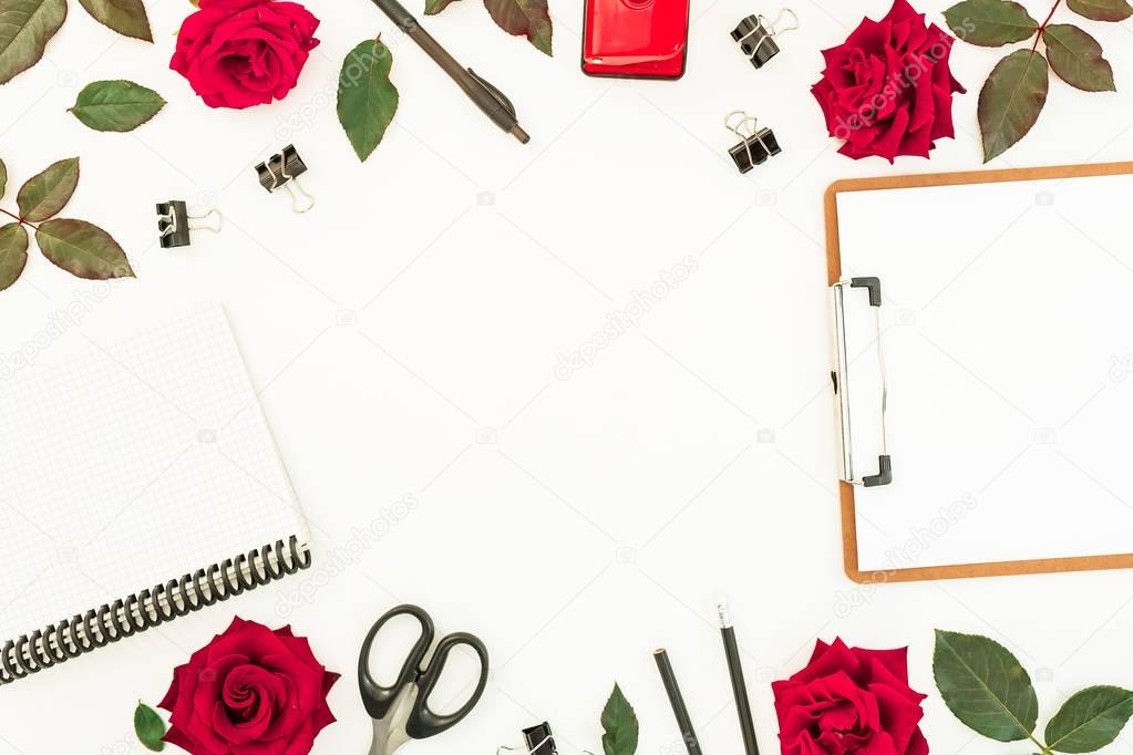 Stylish workspace composition with clipboard, notebook,  flowers and accessories on white background. Flat lay, top view