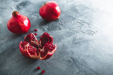 Koyu arka plan üzerinde kırmızı nar. Düz yatıyordu, en iyi görünümü