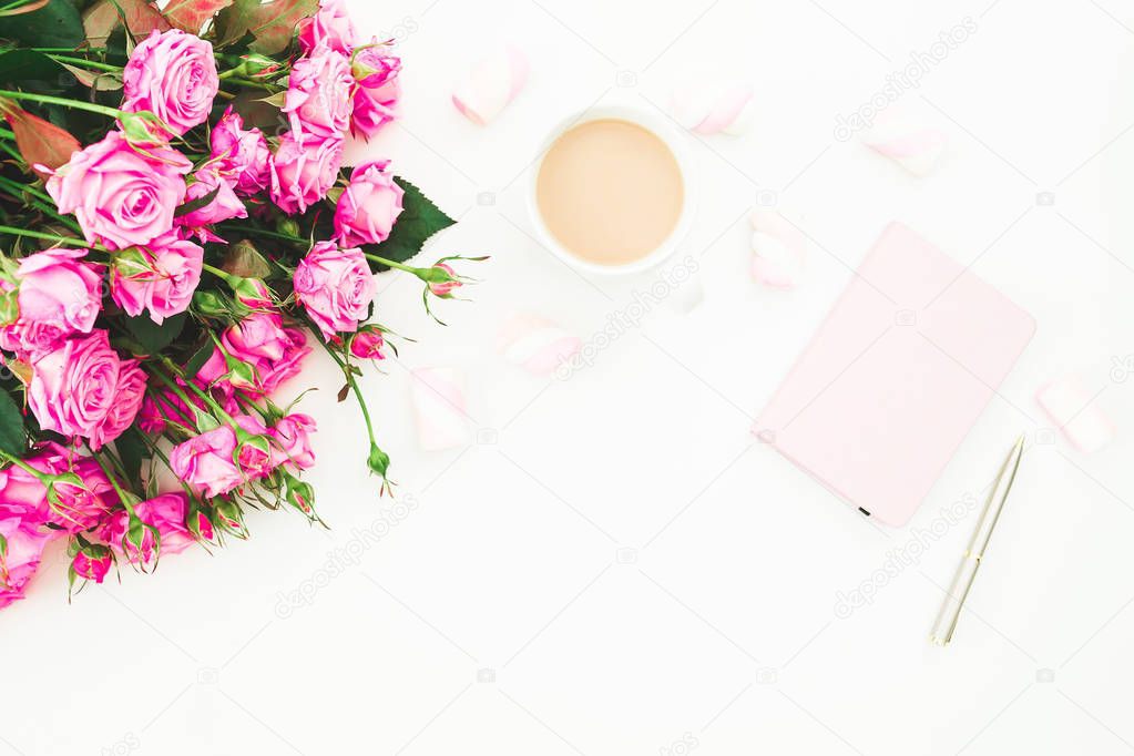 Beauty composition with marshmallows, pink roses bouquet and diary on white background. Top view. Flat lay.