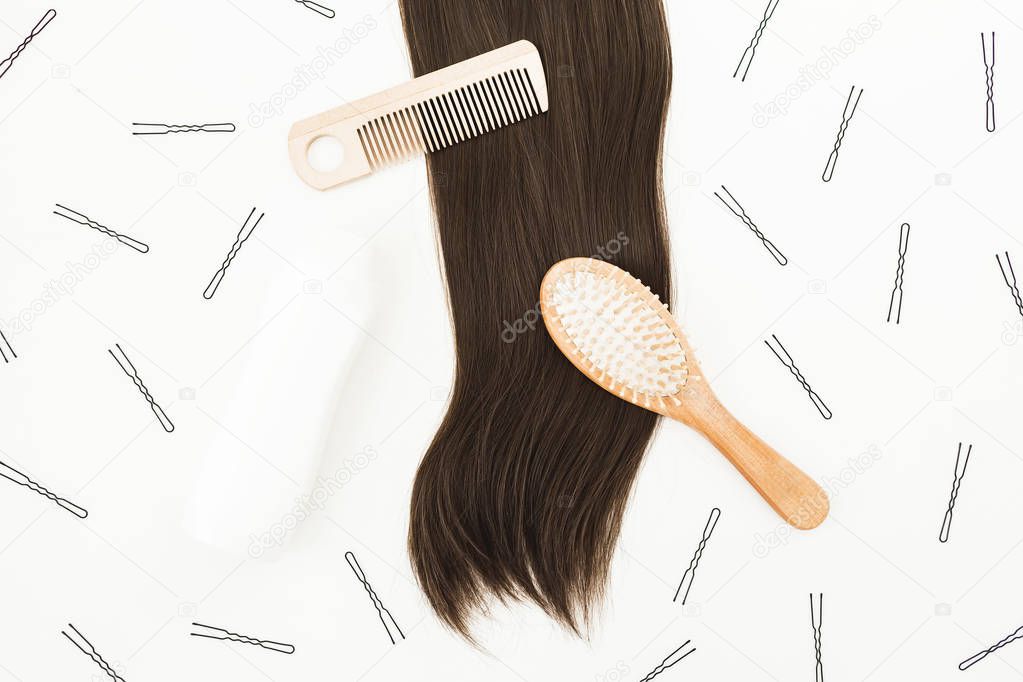 Frame with combs for hair styling, hairpins on white background. Beauty blog composition. Flat lay, top view