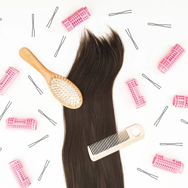 Tools for hair styling and combs on white background. Beauty composition. Flat lay, top view