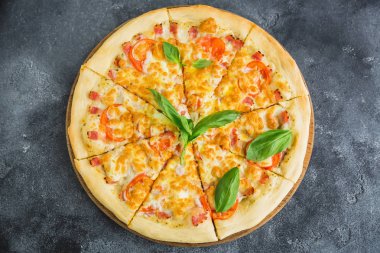 Pastırma, peynir, domates koyu arka plan üzerinde lezzetli pizza. Düz yatıyordu, en iyi görünüm. Gıda arka plan