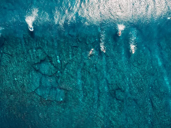 Aerial view with surfers and wave in crystal ocean. Top view — Stock Photo, Image