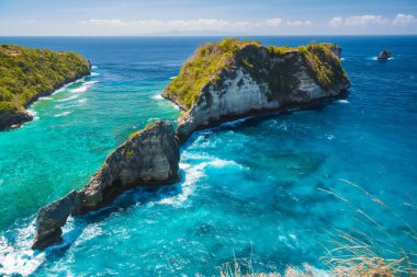 Rocky islands in blue ocean near Nusa Penida island. Bali