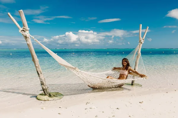 Young woman in bikini relax in hammock at tropical beach. Tropic — Stock Photo, Image